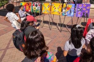 USC students view paintings to be used as banners for Hispanic Latinx Heritage Month.