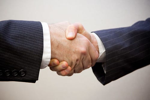 A business deal is sealed with a handshake.